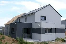 Modern two-story house with a gray and black exterior and several windows.